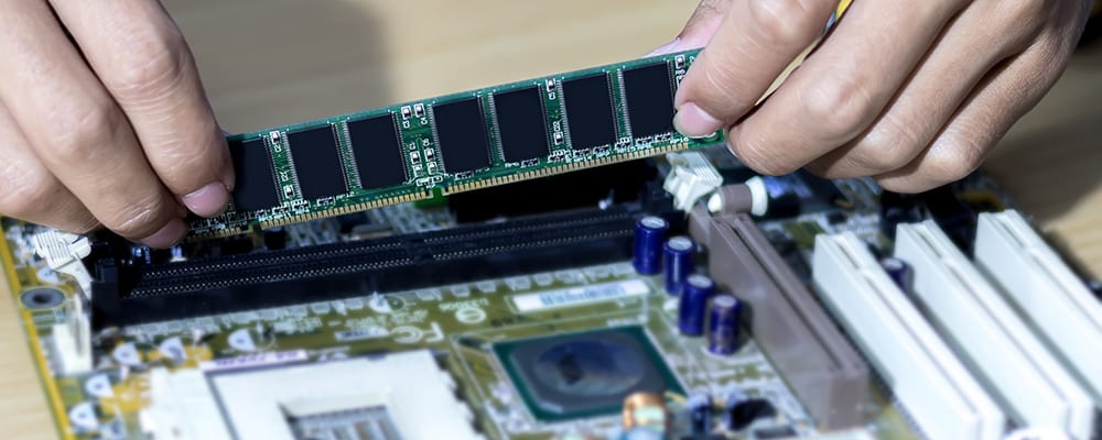 Man putting RAM on the motherboard