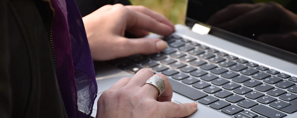 Person using laptop closeup