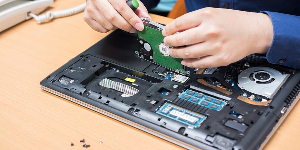 Technician fixing laptop