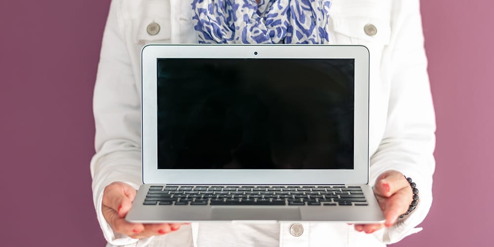 Woman holding laptop